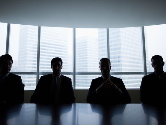 Silhouette row of businessmen sitting in meeting roomMen boardroom business company directors