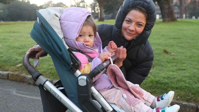 Elissa and her daughter, Zoe, were rugged up for a wintry stroll at the Carlton Gardens. Picture: David Crosling