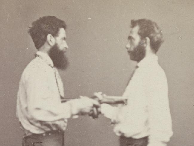 One of two studio portrait photographs, carte de visite size, of Charles Marks (right) and Edward Feeney. One shows them shaking hands and one has them pointing pistols at each other's chests. They apparently made a suicide pact and commissioned photographs of themselves with the guns beforehand. Feeney killed Marks but remained unscathed himself. He was later hanged for murder. Please credit State Library Victoria.