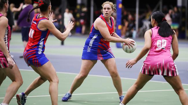 Sharks veteran Lou Dutton shifts the ball down the court in the Cairns Netball match between Leprechauns and Sharks. PICTURE: BRENDAN RADKE