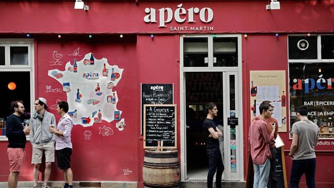 People drink appetisers outside a bar near the Canal Saint-Martin in Paris. Picture: AFP.