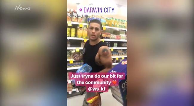 Parramatta Eels player Josh Hoffman and Will Smith are pictured giving food to a homeless man in Darwin