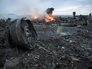 A man walks amongst the debris at the crash site of a passenger plane near the village of Grabovo, Ukraine, Thursday, July 17, 2014. Ukraine said a passenger plane carrying 295 people was shot down Thursday as it flew over the country, and both the government and the pro-Russia separatists fighting in the region denied any responsibility for downing the plane. Picture: Dmitry Lovetsky