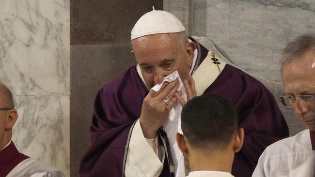 Pope Francis wipes his nose during the Ash Wednesday Mass opening Lent, the 40-day period of abstinence and deprivation for Christians before Holy Week and Easter, inside the Basilica of Santa Sabina in Rome.