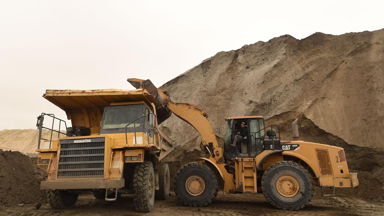 Tractors work at the Metlaoui phosphate production plant on March 8, 2018, in the Metlaoui mining region, one of the main mining sites in central Tunisia... / AFP PHOTO / FETHI BELAID