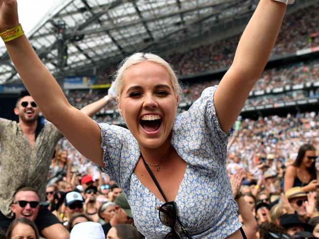 Fans in the crowd during the Fire Fight Australia bushfire relief concert at ANZ Stadium in Sydney, Sunday, February 16, 2020. (AAP Image/Joel Carrett) NO ARCHIVING