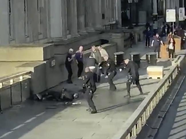 The terrorist is surrounded by police after the knife attack on London Bridge. Picture: @HLOBlog via AP