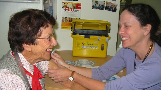 Dr Vicky Sheppeard administers a flu vaccine.