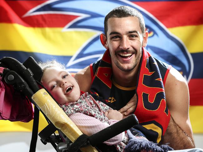 April Williams, 6, who has a rare degenerative condition called metachromatic leukodystrophy, with Crows co-captain Taylor Walker, her favourite player. Picture: Sarah Reed