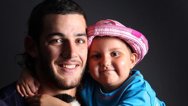 HERO: Taylor Walker with young leukaemia patient Lily Block after cutting his famed mullet for the Leukaemia Foundation.