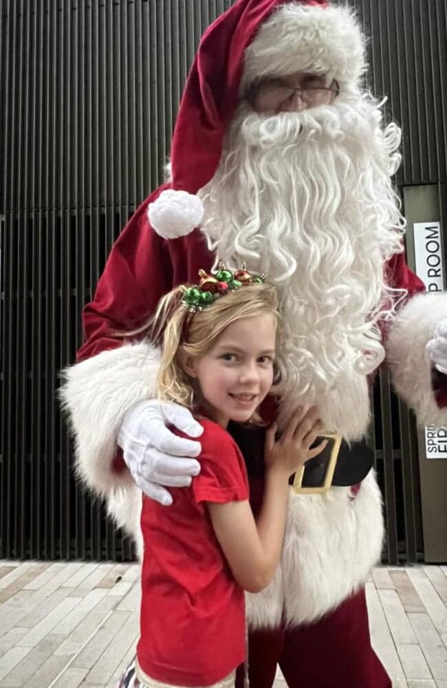 Matilda Hancock cuddling Santa: CBD Christmas Markets 2023 - Rockhampton. Sent in by her mum, Sally Hancock.