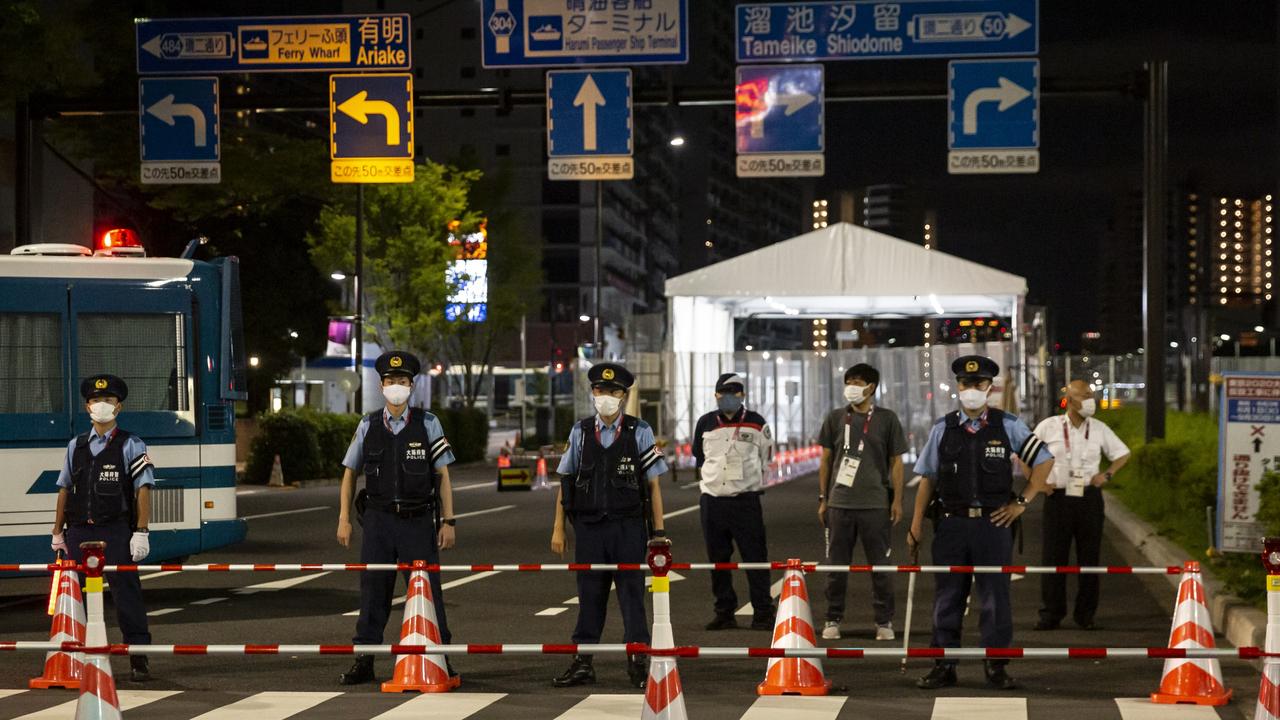 Police officers stand outside the cordoned off Olympic village. Picture: Getty Images