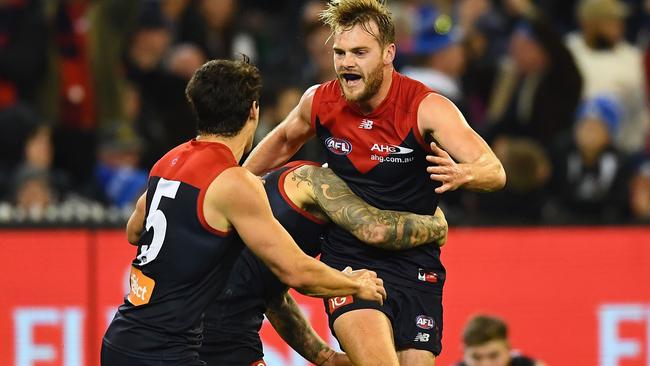 Jack Watts kicks the sealer and celebrates with Nathan Jones and Christian Petracca.