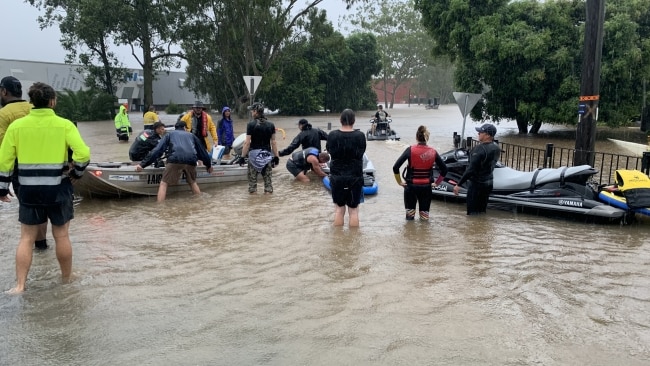Residents were seen using boats and other watercraft to help in the rescue efforts. Picture: Stuart Cumming