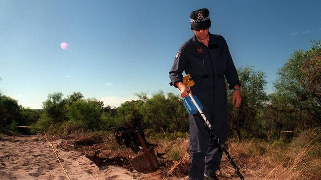 April 1997: Senior Constable Dave Mallows of WA Police Bomb Squad uses metal detector to search for clues near where Ciara Glennoon’s body was found. Picture: News Corp Australia