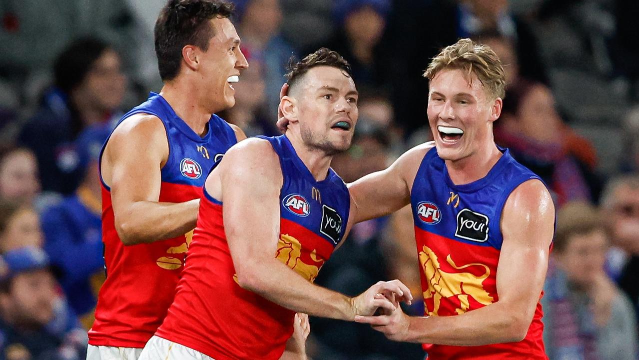 Lachie Neale celebrates a goal with teammates. Photo by Dylan Burns/AFL Photos via Getty Images.