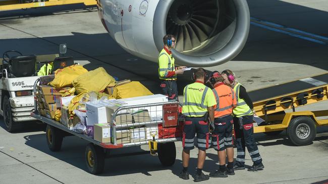 Qantas airport baggage handlers at work. The airline is planning to outsource the work to a “specialist company” to save $100m a year. Picture: Supplied.