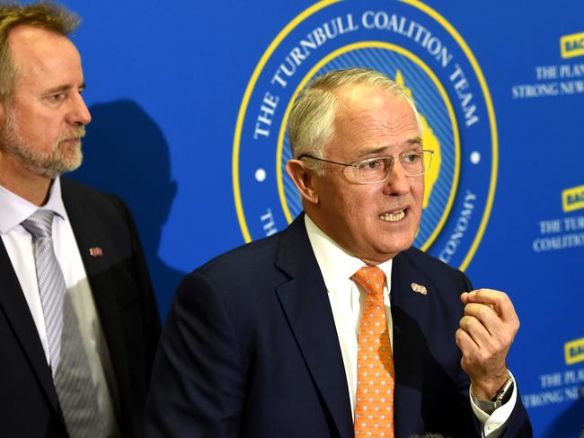 Australian Prime Minister Malcolm Turnbull and Federal Minister for Indigenous Affairs Nigel Scullion (left) speak to the media during a visit to the Gilimbaa Digital Creative Agency in the federal seat of Griffith in South Brisbane, Friday, May, 27, 2016. Mr Turnbull will unveil a plan to ramp up indigenous business, pledging $115 million while campaigning in Brisbane. (AAP Image/Tracey Nearmy) NO ARCHIVING