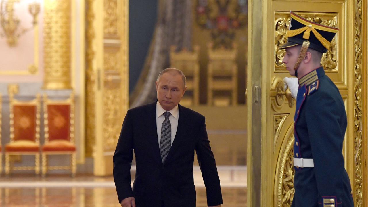 Russian President Vladimir Putin enters a hall to attend a meeting with graduates of the country's higher military schools at the Kremlin in Moscow on June 21, 2022. (Photo by Kirill KALLINIKOV / Sputnik / AFP)