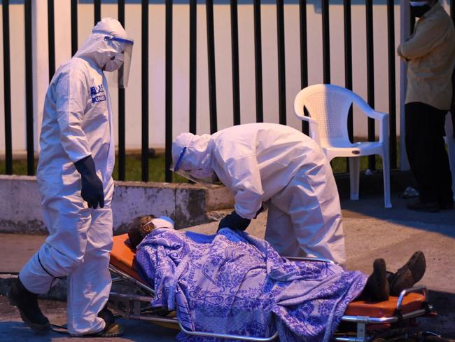 Firefighters transfer a patient infected with the coronavirus in Guatemala City. Picture: AFP