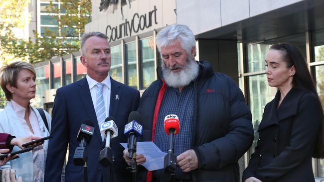 Family members of the police officers who lost their lives in the Eastern Freeway tragedy gather to make a statement after the case. Picture: NCA NewsWire/David Crosling