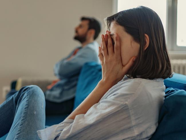 Unhappy Couple After an Argument in the Living Room at Home. Sad Pensive Young Girl Thinking of Relationships Problems Sitting on Sofa With Offended Boyfriend, Conflicts in Marriage, Upset Couple After Fight Dispute, Making Decision of Breaking Up Get Divorced istock image