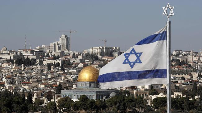 The Israeli flag flutters in front of the Dome of the Rock mosque and the city of Jerusalem.