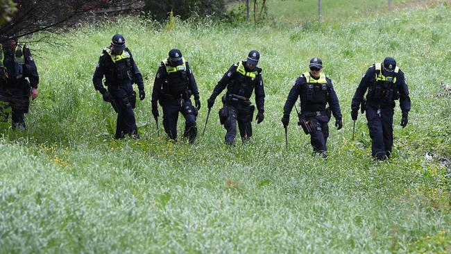 Police conduct a line search at Dandenong Creek in Bayswater after the EastLink shooting. Picture: AAP