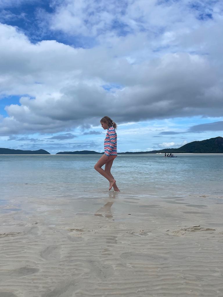 Eloise strolls across the white sand on incredible Whitehaven Beach, Whitsunday Island. Picture: Kara Jung