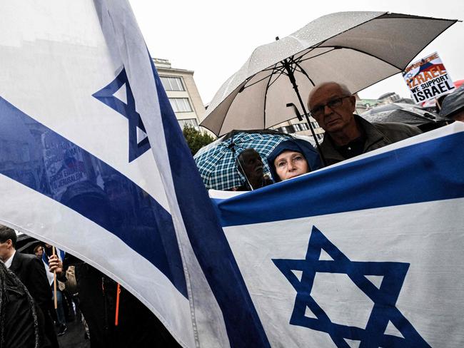 Demonstrators march with the flag of Israel during a rally in support of Israel in Prague. Picture: Michal Cizek/AFP