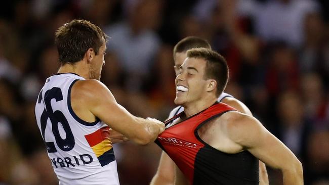 Richard Douglas of the Crows and Zach Merrett of the Bombers clash during the match on Friday night. Picture: Michael Willson/AFL Media/Getty Images