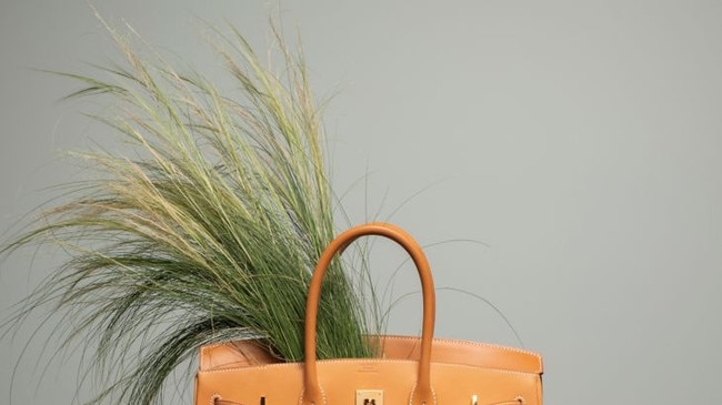 An Hermes Birkin bag in the brand's signature orange hue