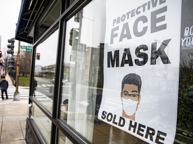 A sign advertising protective face masks is taped in the window of the coronavirus pop-up store in Washington as buyers rush for protective equipment. Picture: Getty