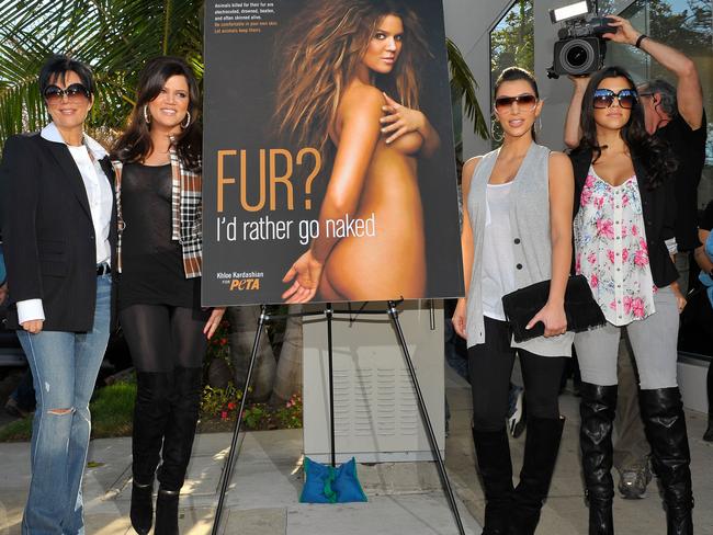 Kris Kardashian, Khloe Kardashian, Kim Kardashian, and Kourtney Kardashian pose as Khloe Kardashian unveils her PETA "Fur? I'd Rather Go Naked" billboard in 2008. Picture: Getty