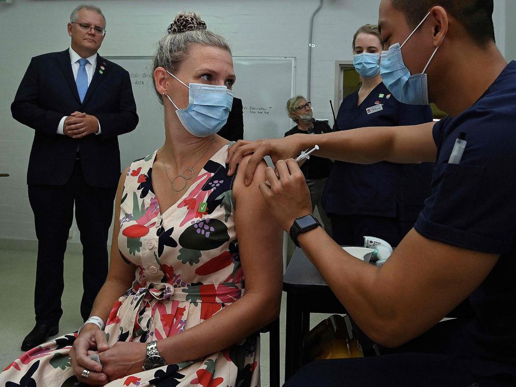 Australian Prime Minister Scott Morrison watches as Sarah Fletcher is taken through the procedure during a simulation of the COVID-19 vaccine process in Sydney on Friday. Picture: Kate Geraghty/AFP