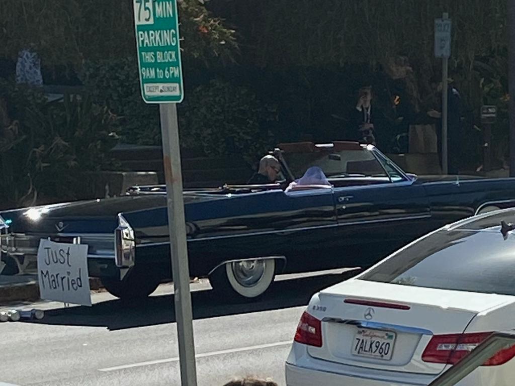 The loved-up couple drove away in a convertible with ‘Just Married’ signs. Picture: BACKGRID