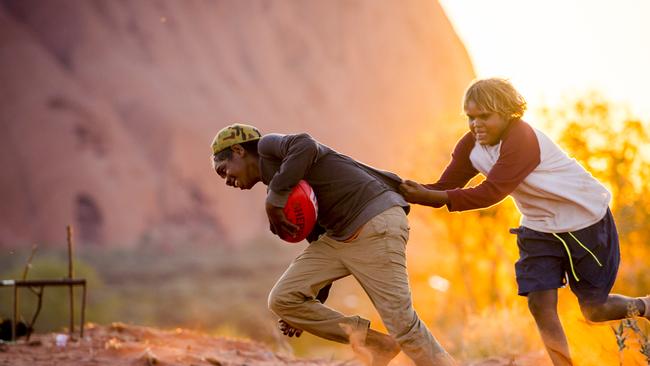 Kids of the Mutitjulu community play footy. Picture: JASON EDWARDS