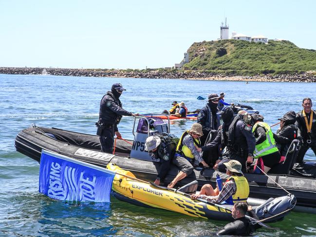 NSW Police stop climate protesters as they paddle out to the shipping channel. Picture: Roni Bintang/Getty Images