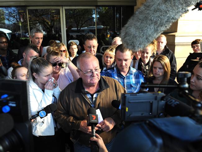 Keith Woodford reads a statement to the media outside the Supreme Court, with his daughter Alison and son Gary, after Dudley Davey was jailed for 32 years for killing his wife Gayle. Picture: Greg Higgs