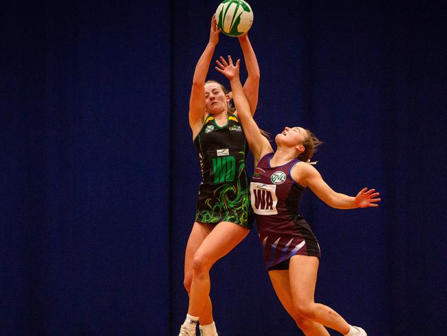 Cavaliers wing defence Asha Lowe and Cripps wing attack Maya Armstrong clash in the air in the U19 state netball grand final at Launceston's Silverdome. Picture: PATRICK GEE/SUPPLIED