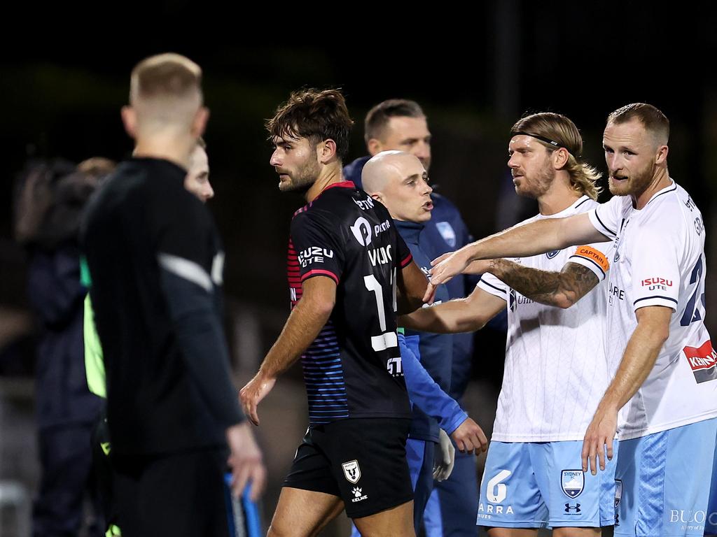 Sent-off Bulls defender Ivan Vujica (centre) leaves the field after being consoled by Sydney FC pair Luke Brattan (second from right) and Rhyan Grant (right). Picture: Brendon Thorne/Getty Images