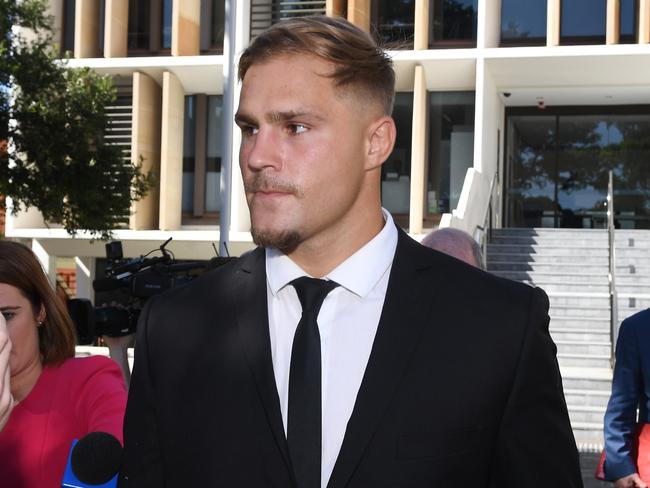 St. George Illawarra Dragons player Jack de Belin (centre) leaves Wollongong Local Court in Wollongong, Tuesday, February 12, 2019. (AAP Image/Dean Lewins) NO ARCHIVING