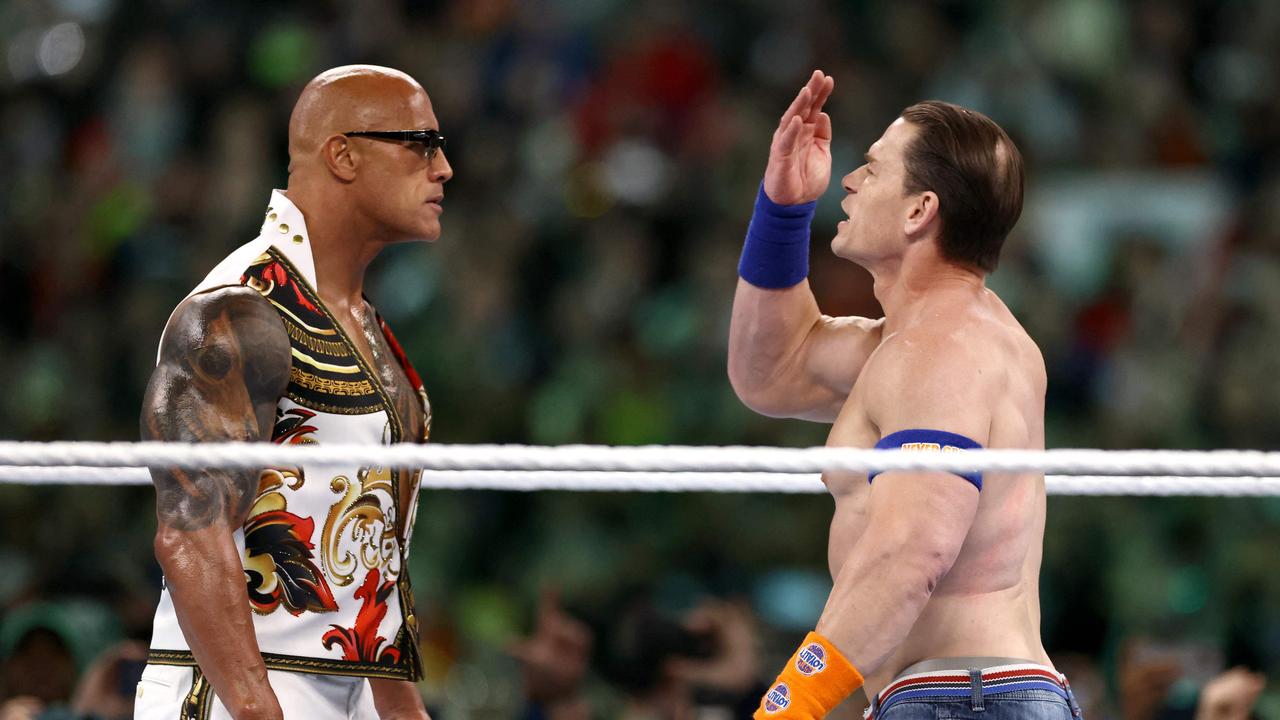 Dwayne "The Rock" Johnson and John Cena fight at WrestleMania earlier this year. Photo: Tim Nwachukwu/Getty Images/AFP.