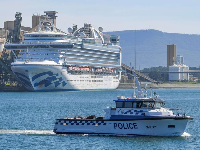 Water police patrol the contaminated cruise ship Ruby Princess while it berths in Port Kembla in April. Picture: Simon Bullard