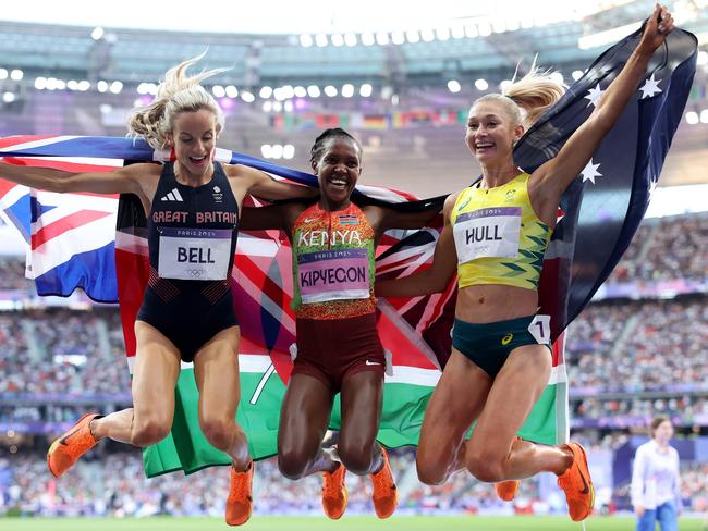 Gold medallist and new Olympic record holder Faith Kipyegon (centre) celebrates with silver medallist Jessica Hull (right) and bronze medallist Georgia Bell (left). Picture: Getty Images