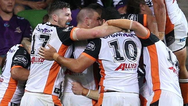 Wests Tigers players celebrate during their win over Melbourne Storm.