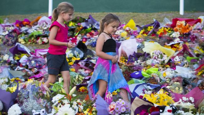 Mourners attend a candlelight vigil outside Dreamworld. (Photo by Glenn Hunt/Getty Images)