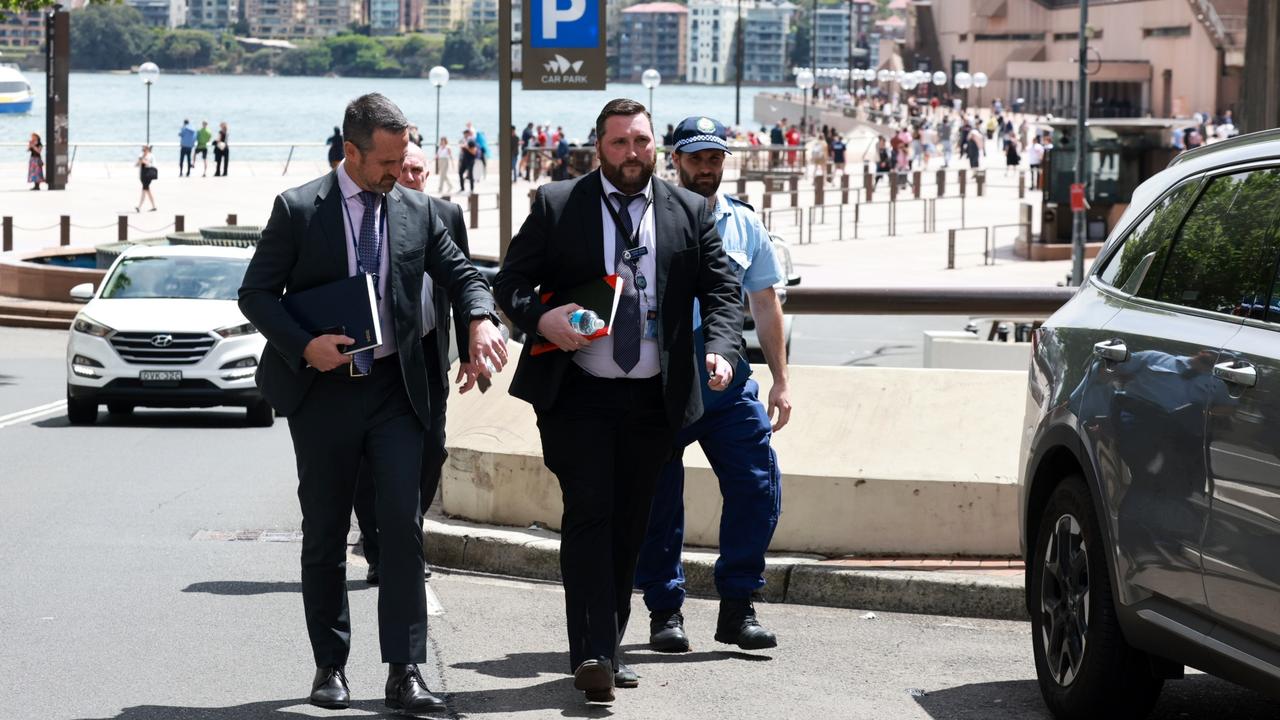 Detectives entering Alan Jones’ apartment in Circular Quay. Picture: Matrix