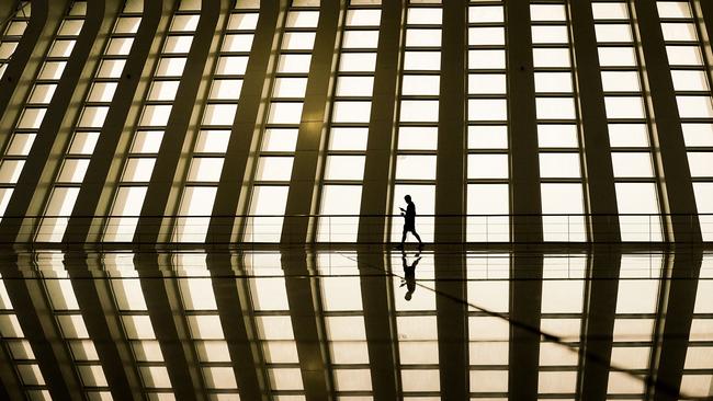 A passenger waits to board a high-speed train at a near-deserted rail station in Shanghai, China. Picture: Getty Images