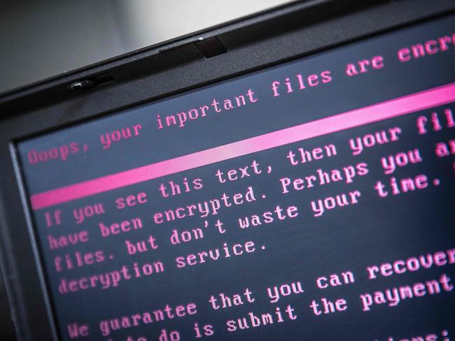 A laptop displays a message after being infected by a ransomware as part of a worldwide cyberattack on June 27, 2017 in Geldrop.  The unprecedented global ransomware cyberattack has hit more than 200,000 victims in more than 150 countries, Europol executive director Rob Wainwright said May 14, 2017. Britain's state-run National Health Service was affected by the attack. / AFP PHOTO / ANP / Rob Engelaar / Netherlands OUT